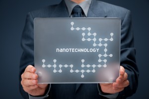 Nanotechnology concept. Man holding futuristic tablet pc with nanotechnology design.